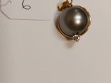 a close up of a small black pearl on a white surface