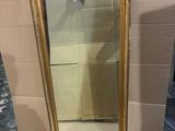 a mirror that is sitting on the floor next to a wall