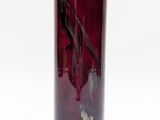 a red glass vase with a horse on it