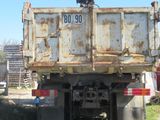 a dump truck that is sitting in the grass