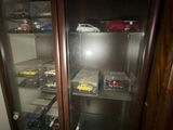 une vitrine en verre contenant de nombreuses petites voitures