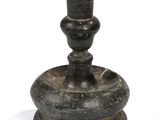a small black candle holder on a white surface