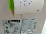a white refrigerator with a note taped to it ' s side