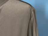 the back of a gray shirt with a black collar and a black tie