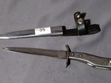 two knives that are laying on a table