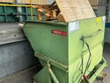 a green dumpster sitting on the side of the street