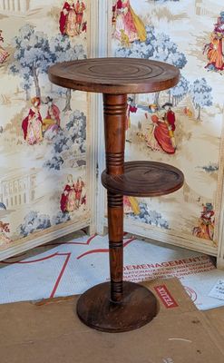a small wooden table with a shelf on top of it