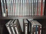 a lot of dvds on a shelf in a book case