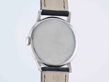 a close up of a watch on a white surface with a white background