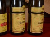 three bottles of wine sitting on a table next to each other