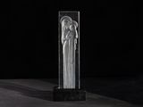 a clear glass sculpture of an angel on a black background