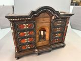 a small wooden cabinet with a fire place inside of it