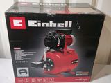 the box of a small air compressor is open on the table