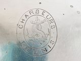 a close up of a metal plate with a logo on it