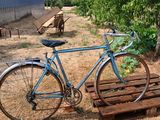 a bike that is parked next to a wooden pallet