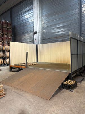a skateboard ramp in the middle of a warehouse