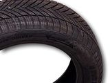 a close up of a tire on a white background with a tag
