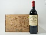 a bottle of wine sitting next to a wooden box