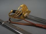 two swords that are sitting on a table