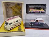 three toy cars in a display case on a table
