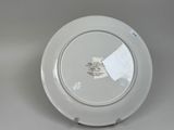 a white plate with a picture on it sitting on a table