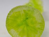 a close up of a piece of lime on a white surface