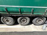 a green semi truck that is parked on the side of the road