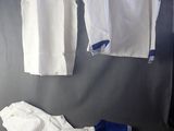 two shirts and a pair of pants hanging on a wall