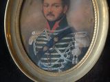 portrait of a man in a military uniform in a gold frame