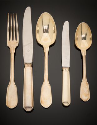 four forks and a knife on a table with a black background