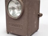 a small brown light that is on a white surface
