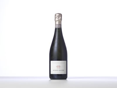 the bottle of wine is sitting on the table with a white background