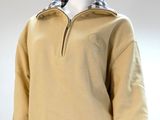 an image of a mannequin wearing a tan sweater with a checkered collar