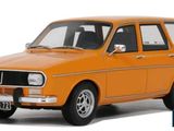 the small orange car is parked on a white surface