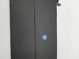 a close up of a black door with a blue sticker on it
