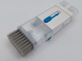 a close up of a toothbrush on a white surface with a blue handle