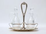 an image of a silver plate with two glass decanters on it