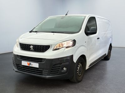 the small white van is parked in a large room