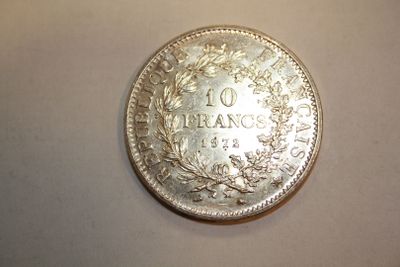 an image of a silver coin with the number 10 on it