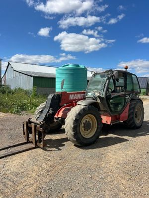a tractor that is parked on the side of the road