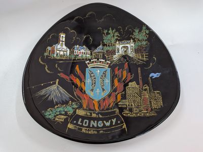 a black plate with a picture of a city on it