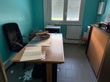 a desk and a chair in a room with blue walls