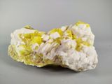 yellow and white mineral on a gray surface