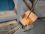 an orange box sitting on top of a pallet next to a blue box