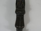 a wooden carving of a man with a hat on