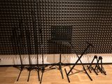 three microphone stands in front of a wall of sound foam