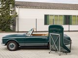 a green convertible car parked in front of a building