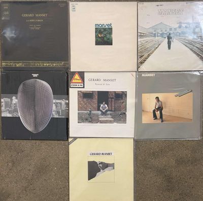 several albums are stacked on top of each other on the floor