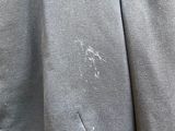a close up of a person ' s jacket with a hole in the back of it