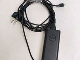 a dell charger attached to a cord on a table